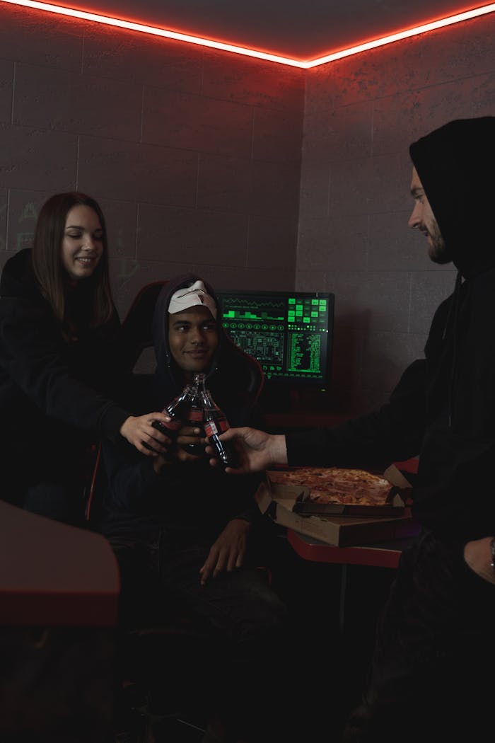 Group of coworkers celebrating a successful project with cheers and pizza.